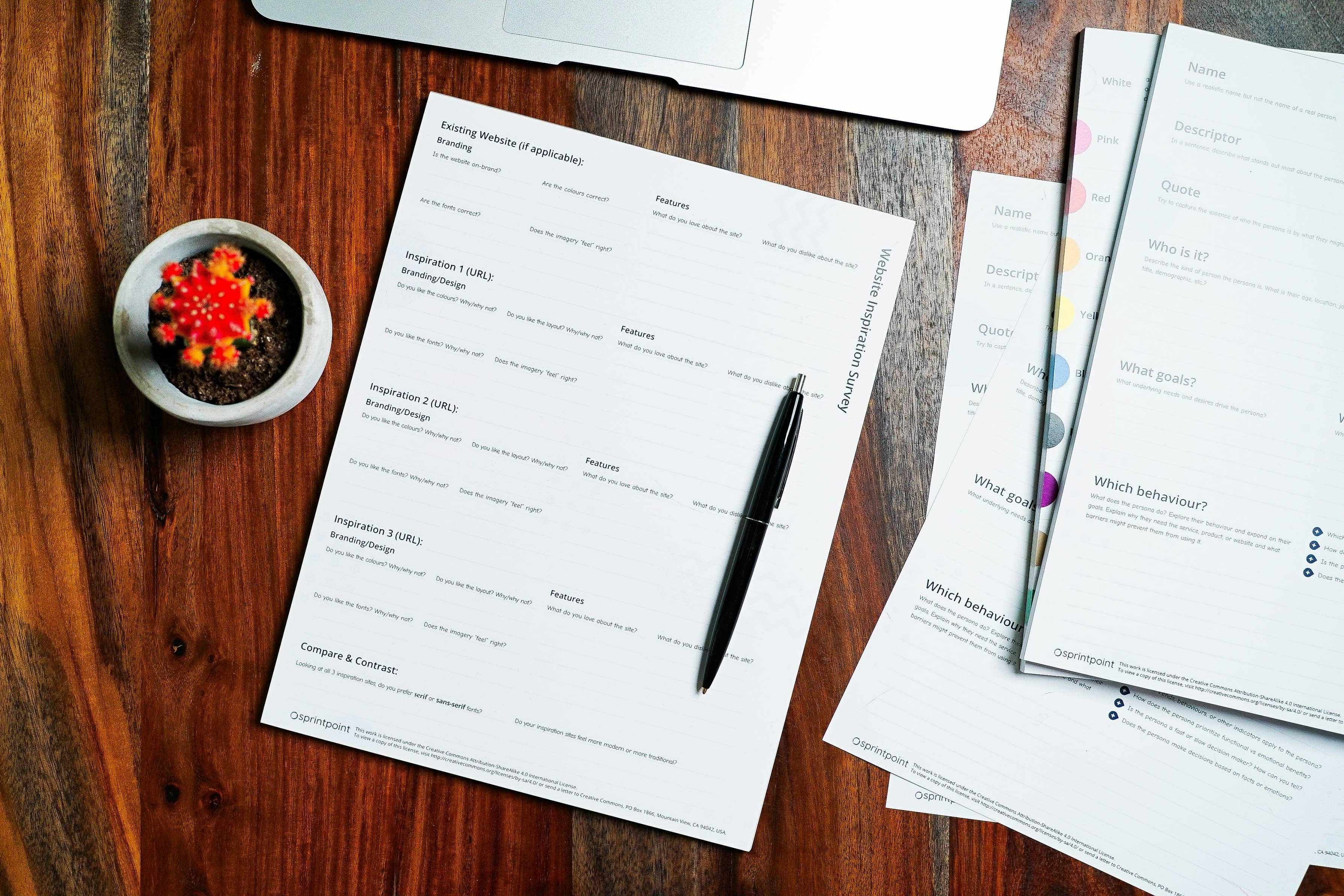 Printed documents and a pen on a desk