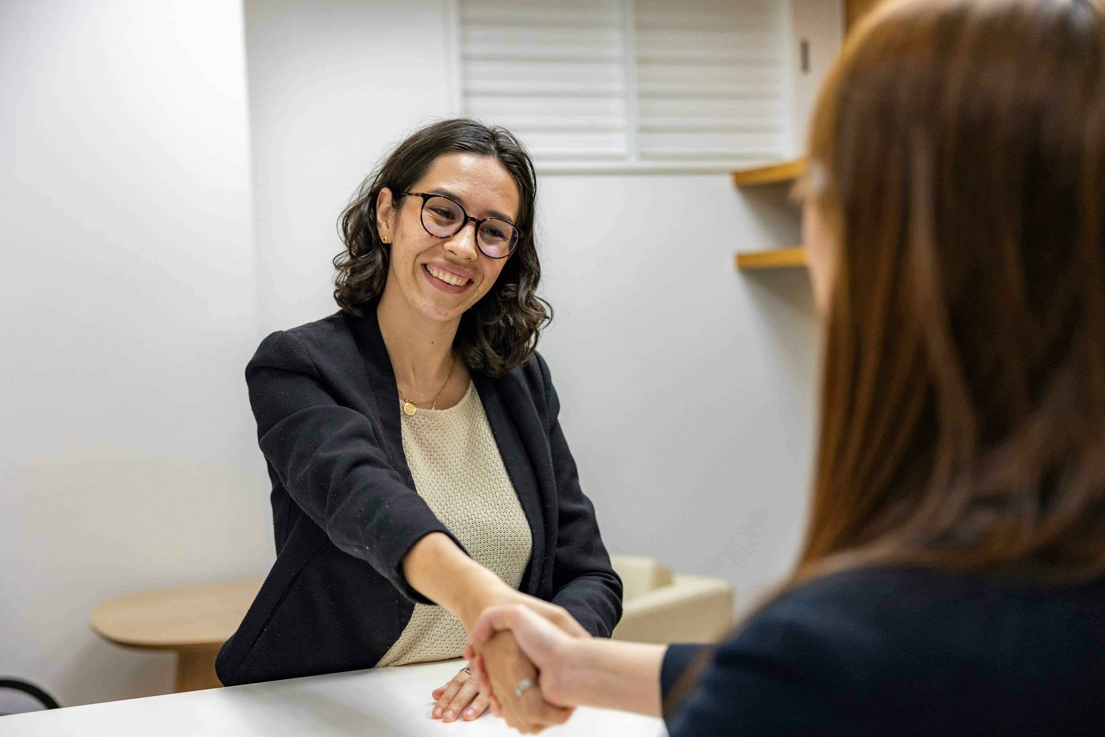Two people meeting across a desk